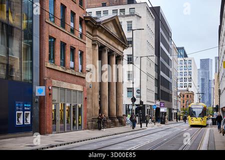 Manchester Lower Mosley Street tram passing he Portico Library and Bank pub Stock Photo