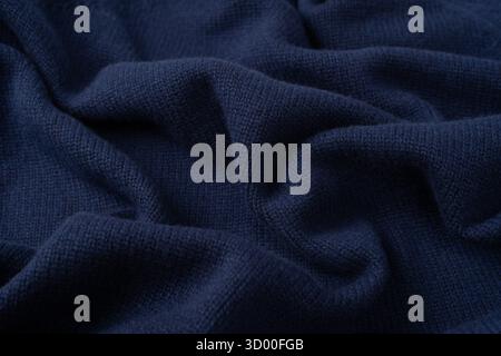 Navy blue merino wool sweater texture as background. Top view. Stock Photo