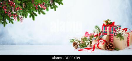 Christmas Gift Boxes with Pine Branches and Festive Decor Stock Photo