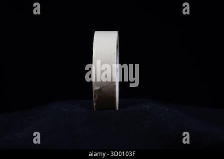 single white roll of decorators masking tape isolated on a black background Stock Photo