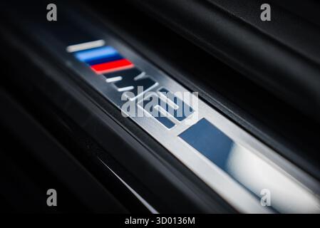 BMW M2 door sill plate with M stripes and badge in workshop Stock Photo