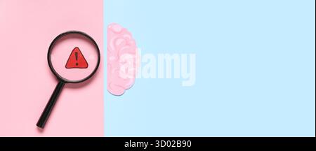 Paper human brain, warning sign and magnifying glass on color background with space for text, top view Stock Photo