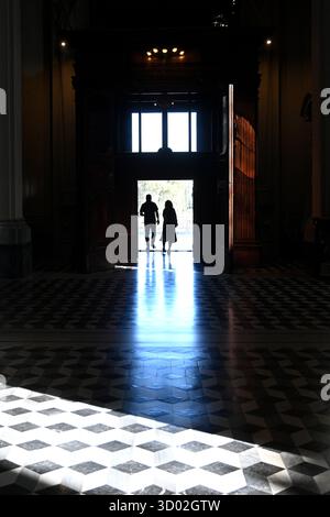 Silhouettes of people in the doorway of a church in Rome, Italy Stock Photo