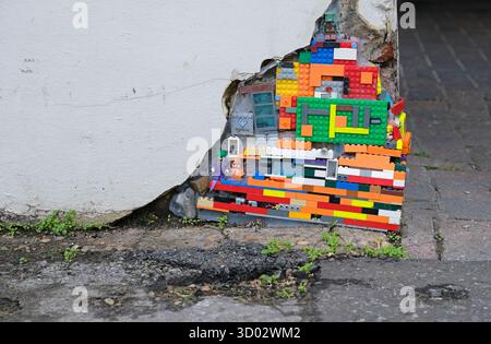 colourful lego bricks in corner of building wall Stock Photo
