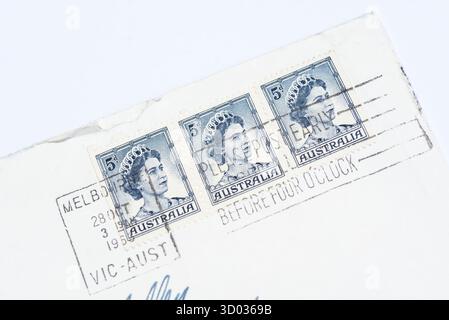 Australian postage stamps on an envelope posted to the UK in the 1960s. Pre-decimal 5d stamp featuring Queen Elizabeth II. Postmarked Melbourne Stock Photo