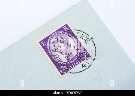 1960s UK pre-decimal 3d postage stamp featuring Queen Elizabeth II on a lilac background with ER. Postmarked Field post office Stock Photo