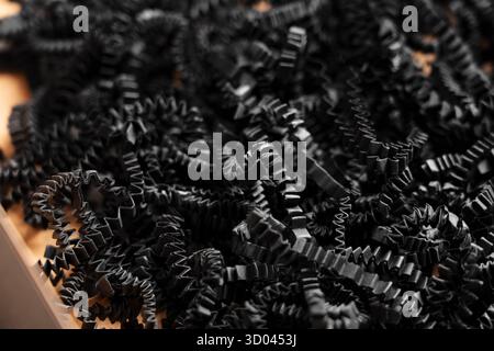 Black paper shredded filler in empty cardboard gift box Stock Photo
