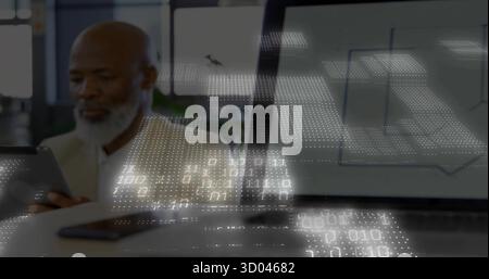 Senior executive wearing blazer using tablet at office desk with laptop charts and smartphone Stock Photo