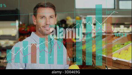 Holding mid adult man displaying orange in produce section, with wooden bins and translucent graphs Stock Photo