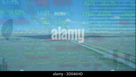Displaying airplane wing through window above runway, showing yellow line graph and percent tickers Stock Photo