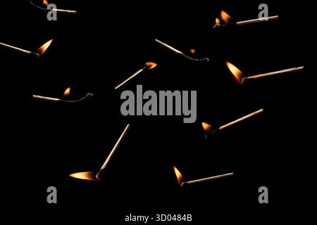 Lit and falling match on a black background. Stock Photo