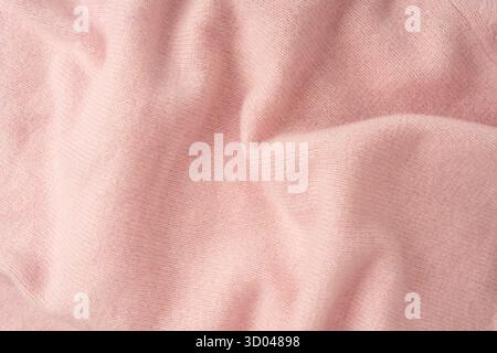 Soft pink cashmere sweater texture background. Top view. Stock Photo