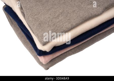 A group of warm sweaters isolated on a white background. Stack of folded sweaters on white background. Stock Photo