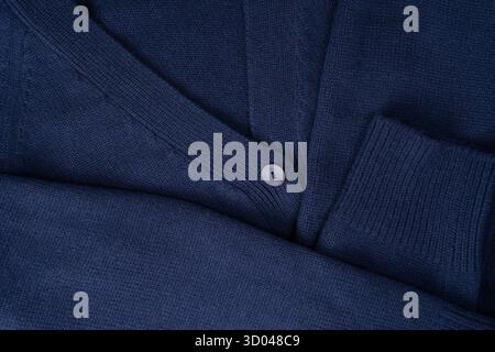 Navy blue merino wool cardigan texture as background. Top view. Stock Photo