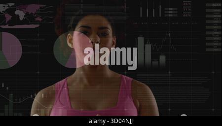 Displaying data analyst in pink sleeveless top in studio, holographic charts and index panel Stock Photo