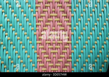 Woven plastic mat grid texture in vibrant Blue, Pink, and Gold. Close-up abstract background ideal for design, luxury packaging, and craft projects. Stock Photo