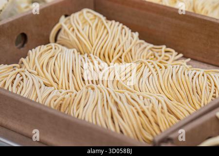 Fresh homemade tagliolini or tajarin for sale in a street food market Stock Photo