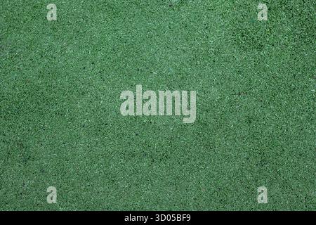 Green sports ground covering, surface of an outdoor sports field. Green artificial grass as a background, aerial view. Stock Photo