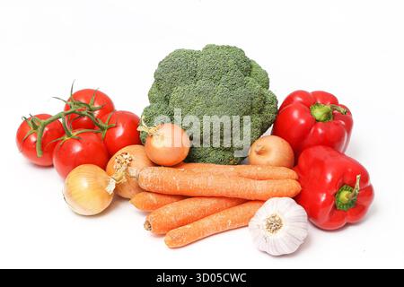 Fresh vegetables assortment on white background. Healthy food with broccoli, tomatoes, carrots, onion and pepper. Stock Photo