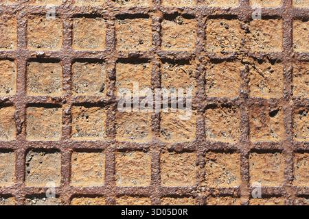 Rusty metal grid surface closeup. Industrial grate texture background. Old steel construction element. Geometric pattern with corrosion details. Stock Photo
