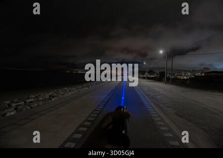 50000MW laser flashlight in black metal cylinder shape with blue light and USB charging Stock Photo