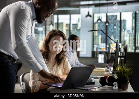 Professional employees team analyzing data visualization and documentation. Colleagues collaborating on forecasting, report sharing and performance tracking for business growth. Stock Photo