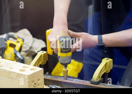 Craftsman using a grinder to cut metal in a workshop with sparks flying. Industry Stock Photo