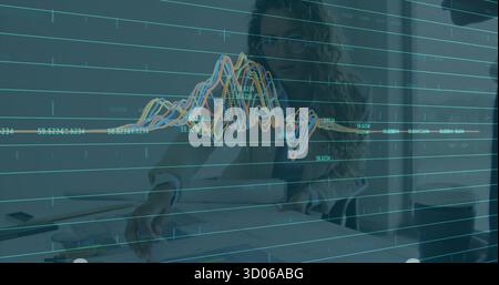 Reviewing two businesswomen analyzing printed charts at office table, with data graph overlay Stock Photo