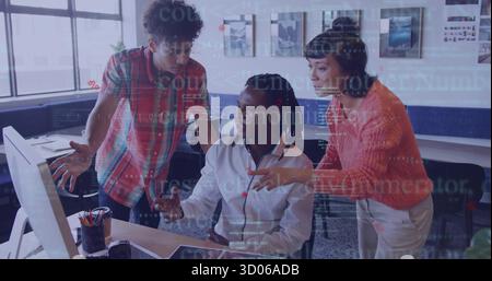 Collaborating three software engineers typing code on monitor in modern workspace, with coffee mug Stock Photo