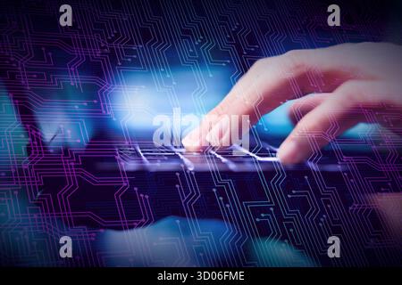 technology concept of a female hand writing on a laptop with a computer circuits over in crossing process technique Stock Photo