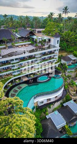 Pool Over View Aerial view of an infinity pool resort overlooking the tropical sea on ...