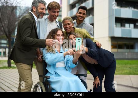 Diverse colleagues taking selfie together in urban setting Stock Photo