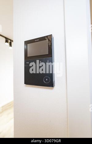 Black video intercom system with display on white wall in modern entrance area, house renovation, energy renovation, Metzingen, Germany Stock Photo
