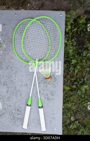 Badminton rackets and tennis ball on green grass Stock Photo - Alamy