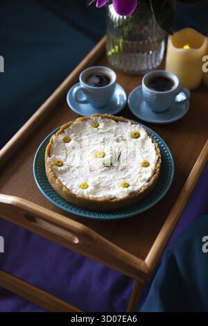 Top view - breakfast in bed a delicious cheesecake and two cups of coffee are on a wooden tray Stock Photo