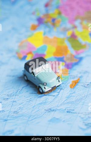 Retro car on colorful world map, travel Stock Photo