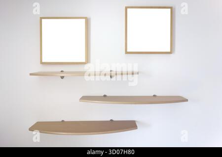 Shelves and photo frames on a wall Stock Photo