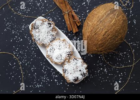 Coconut muffins with chocolate on a black background and whole coconut Stock Photo