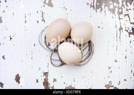 Eggs lie on an old white table Stock Photo