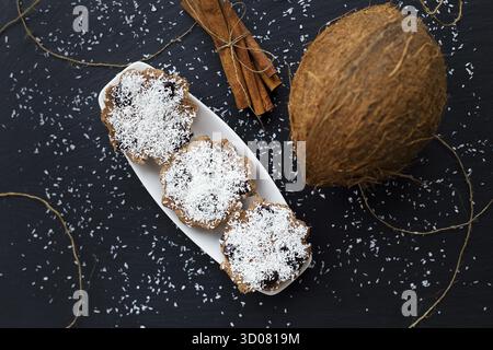 Coconut muffins with chocolate on a black background and whole coconut Stock Photo