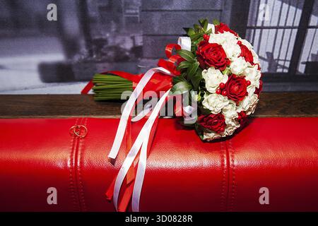 Bouquet of white and red roses stands on the couch Stock Photo