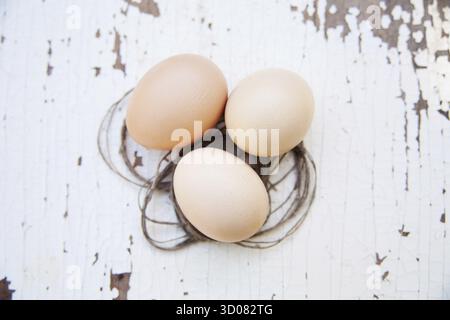 Eggs lie on an old white table Stock Photo