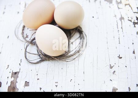 Eggs lie on an old white table Stock Photo