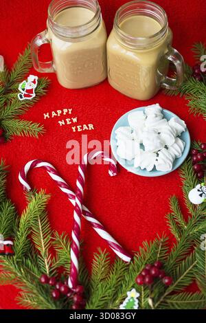 Christmas tree, candy, coffee marshmellou on a red background. The inscription Happy New Year Stock Photo