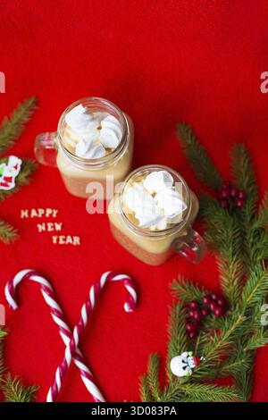 Christmas tree, candy, coffee marshmellou on a red background. The inscription Happy New Year Stock Photo