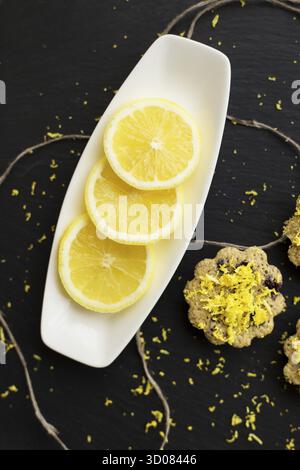 Lemon cupcakes on a black background with lemon zest Stock Photo