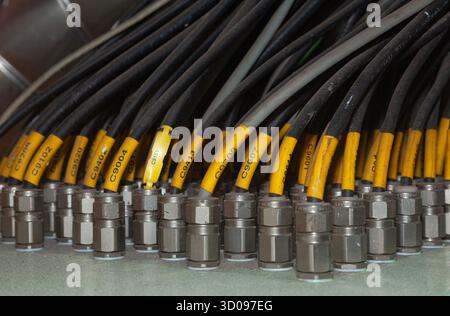 Several powerful electrical cables connected to a junction box Stock Photo