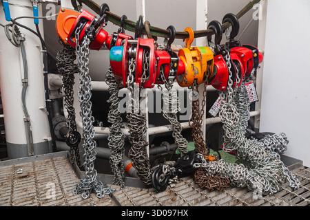 Chain hoists for lifting weights in a workshop close-up Stock Photo