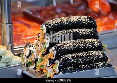 Gimbap rice rolls wrapped in seaweed with vegetables and sesame seeds Stock Photo