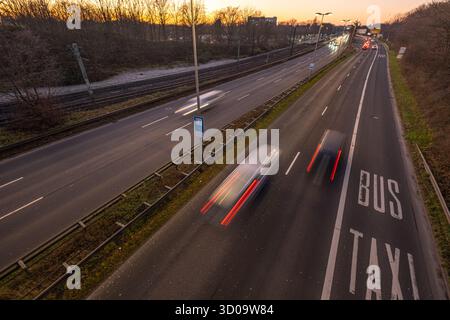 Cars speeding on a highway with motion blur with separated bus and taxi lane on the right Stock Photo